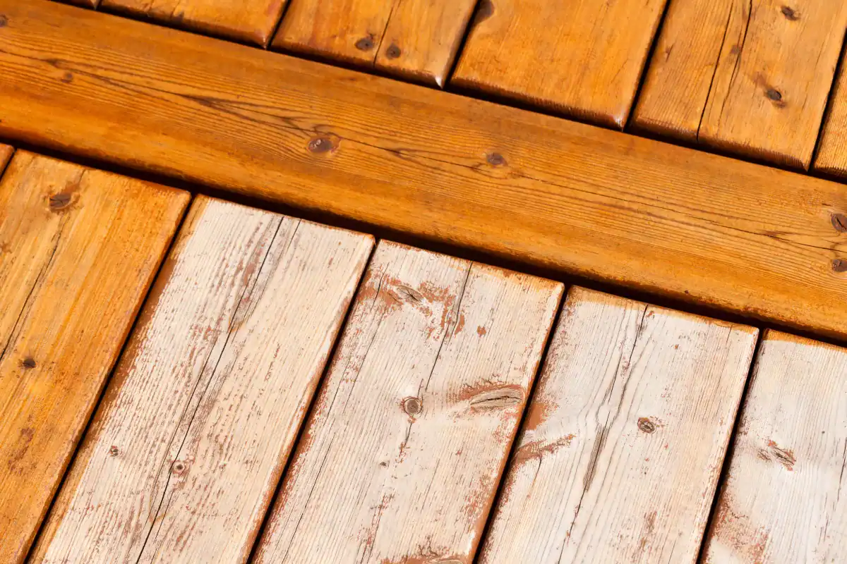 Close-up showing stained versus unstained deck boards side by side